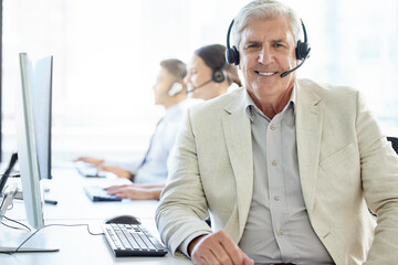 Happy, portrait and mature man in call center to help in customer support to chat online on...
