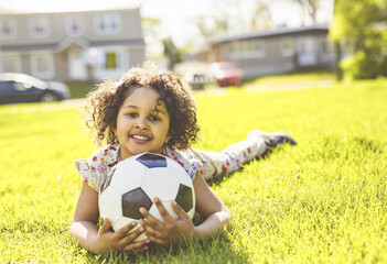 Sports kid. Happy little girl kid with a soccer ball, Child plays