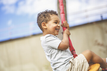 Happy kid on playground on summer season