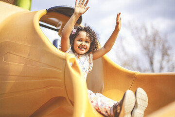 Happy kid slide on playground on summer season