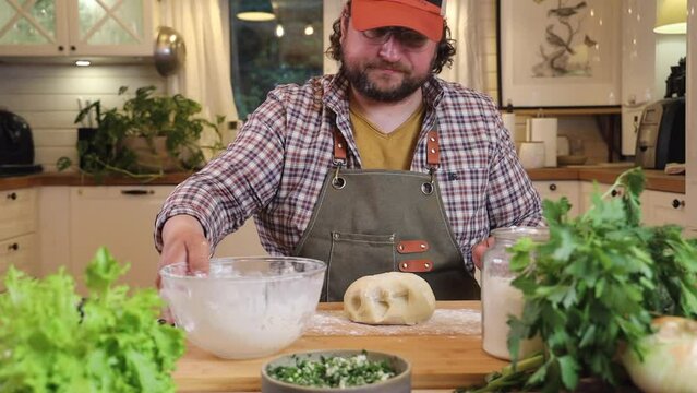 a male chef makes kutab dough in a home kitchen