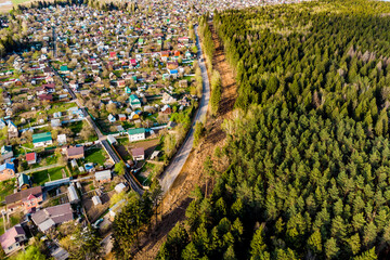 Aerial view of a clearing on the outskirts of the forest near the road, gas laying in the...