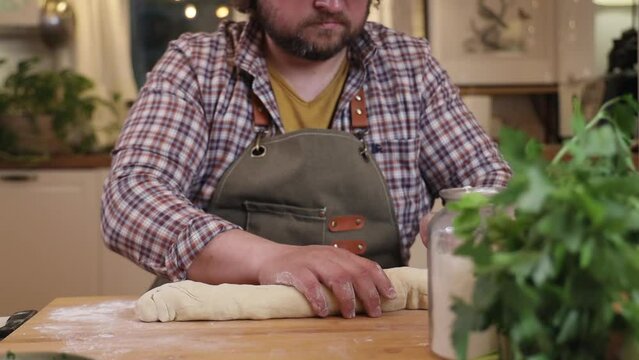 a male chef makes kutab dough in a home kitchen