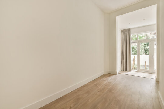 Modern empty room with natural light and wooden floor