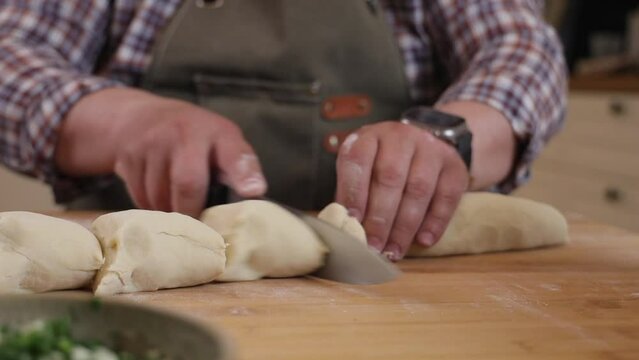 a male chef makes kutab dough in a home kitchen