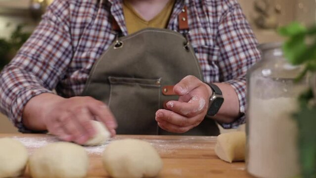 a male chef makes kutab dough in a home kitchen