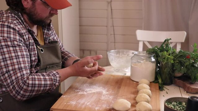 a male chef makes kutab dough in a home kitchen