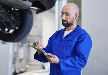 Man, mechanic and writing with clipboard for service, checklist or report on general repair at...