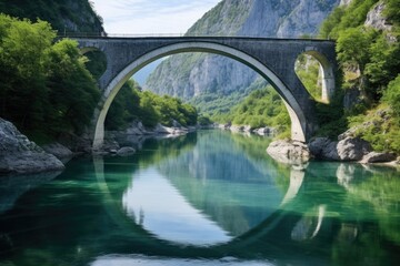 A bridge spans a river with a green reflection on the water