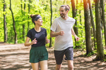 Couple jogging and running outdoors in nature