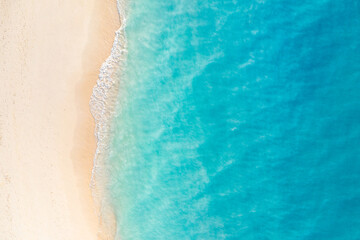 Summer seascape beautiful closeup. Blue sea water in sunny day. Top view from drone. Sea aerial surf, amazing tropical nature background. Mediterranean bright sea bay waves splashing beach sandy coast