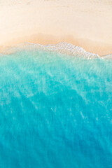 Summer seascape beautiful closeup. Blue sea water in sunny day. Top view from drone. Sea aerial surf, amazing tropical nature background. Mediterranean bright sea bay waves splashing beach sandy coast © icemanphotos
