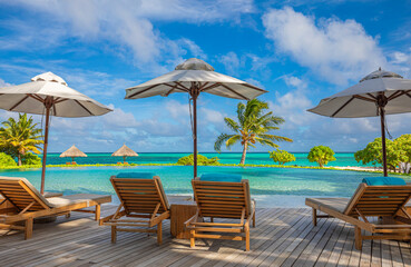 Stunning landscape, swimming pool blue sky with clouds. Tropical resort hotel in Maldives. Fantastic relax and peaceful vibes, chairs, loungers under umbrella and palm leaves. Luxury travel vacation
