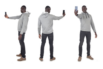 back,side and front view of same man holding a smartphone on white background