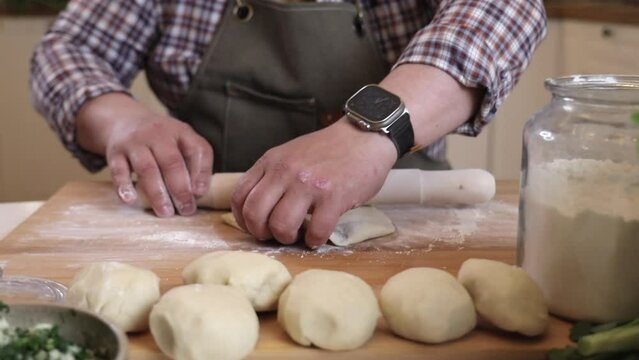 a male chef makes kutab dough in a home kitchen