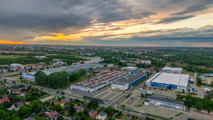 city ​​during sunset from drone. Aerial view of the city skyline, cityscape. View of architecture, industrial plants, warehouses