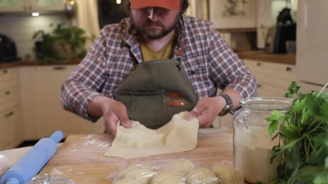 a male chef makes kutab dough in a home kitchen