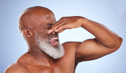 Disgusted, African man and holding nose in studio for body odour and bad or dirty smell. Mature,...