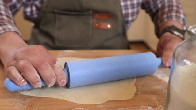 a male chef makes kutab dough in a home kitchen