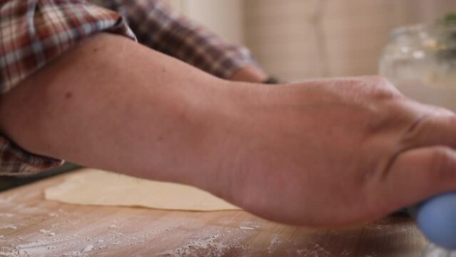 a male chef makes kutab dough in a home kitchen