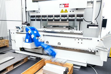 Blurred motion of robotic arm in the factory. Assembly, machine tending, part transfer, pick and place robot arm.
