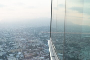 View in downtown Los Angeles California with windows reflecting in foreground from above skyscraper