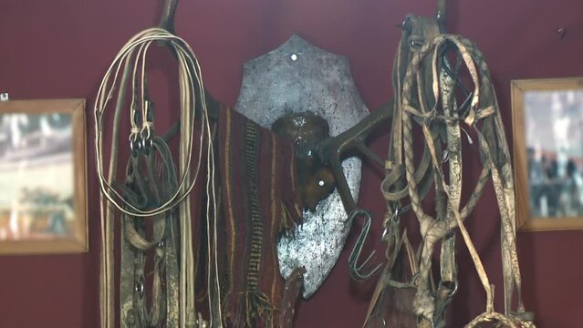 Saddlery, Ropes, Bridles, Leather Strips, and Other Equipment for Horses Hanging from the Wall of a Rural House in Argentina. Close Up.