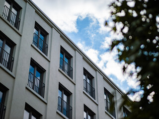 Modern house facade of a residential building in Germany. Low angle view against the sky. The exterior of the architecture is in a contemporary and minimalist design.