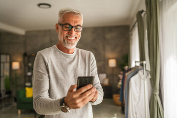 One mature man hold mobile phone and explore internet or text message