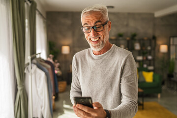 One mature man hold mobile phone and explore internet or text message