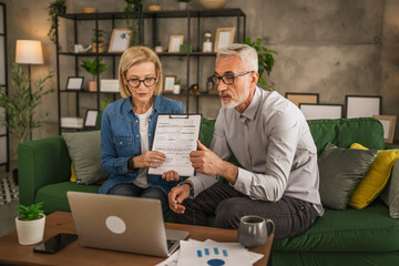 Mature man and woman work form home have consultation via video call