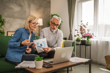 Mature man and woman work form home have consultation via video call