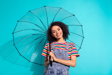 Photo of positive cheerful girl look hold parasol isolated cyan color background