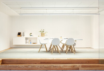 Break, room and furniture in empty modern office or space with table and chairs on floor. Interior,...