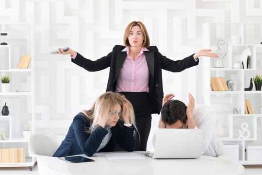 Young businesswoman is dissatisfied with her lazy subordinates