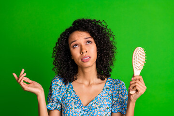 Photo of nice young woman brush look up empty space wear top isolated on green color background