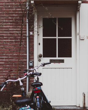 bicycle in front of a white door