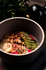 Raw linen cereal with fruits, nuts in bowl. Super food for healthy nutritious breakfast