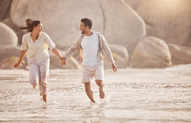 Running, happy couple and holding hands at ocean on vacation, summer holiday or travel outdoor...