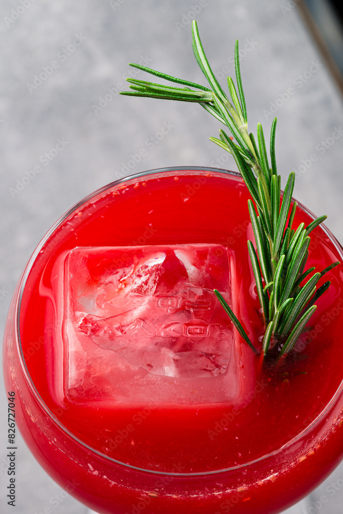 Wall mural Homemade boozy alcoholic pomegranate cocktail with rosemary and vodka, copy space top view