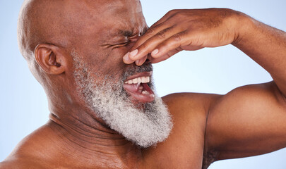 Disgust, African man and holding nose in studio for body scent and bad or dirty smell. Mature, male...
