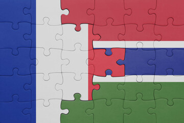 puzzle with the colourful national flag of gambia and flag of france.