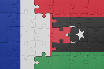 puzzle with the colourful national flag of libya and flag of france.