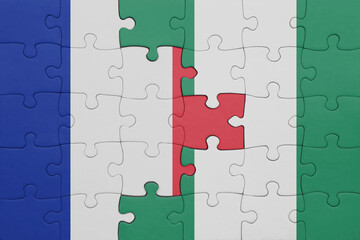 puzzle with the colourful national flag of nigeria and flag of france.