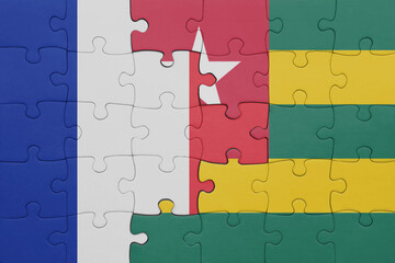 puzzle with the colourful national flag of togo and flag of france.
