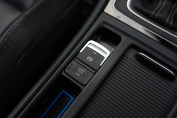 Close-Up of Electronic Parking Brake Control: Modern Vehicle Interior with High-Tech Parking Feature