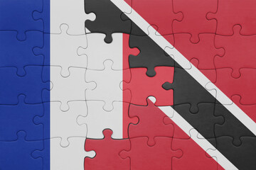 puzzle with the colourful national flag of trinidad and tobago and flag of france.