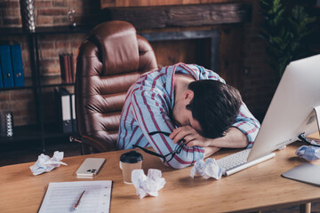 Portrait of young man office worker sleep desktop wear shirt loft interior business center indoors