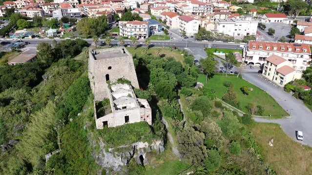 approaching flight aerial view about an ancient Aragonese Castle of sea town Scalea with spectacular panoramic of beach and light blue colored sea
