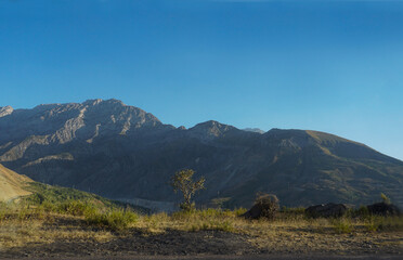 Blue sky above mountain and mountain